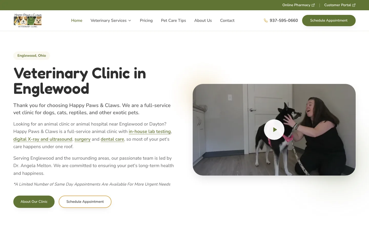 Happy Paws & Claws veterinary clinic homepage featuring a staff member with a dog in Englewood, Ohio